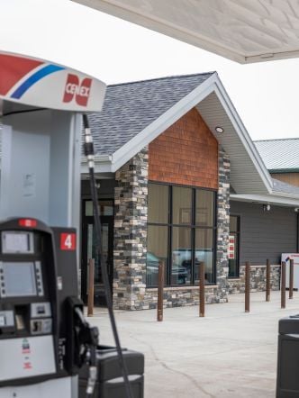 View of a newly built convenience store and fuel pump.