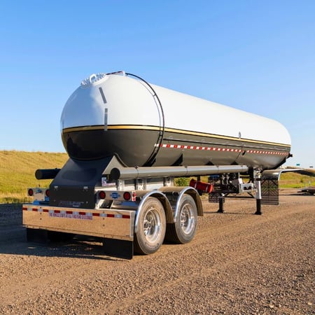Westmor Lightweight Proline transport trailer with white and blue tank parked on a gravel lot.