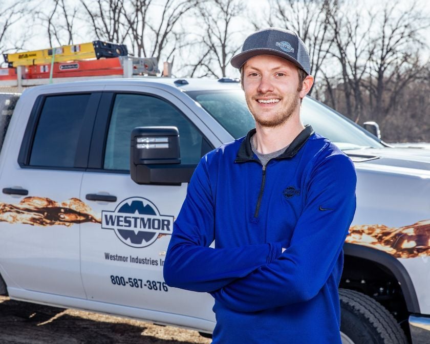 Westmor service tech standing in front of truck.