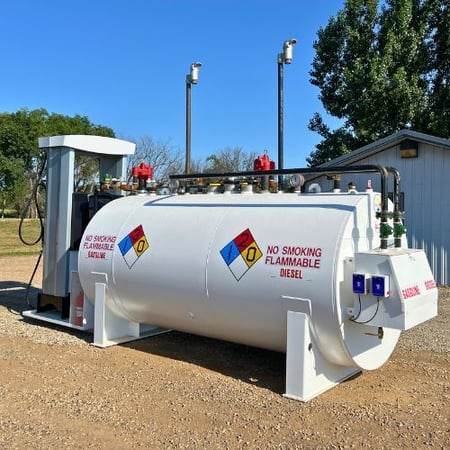 White aboveground fuel storage tank with a dispenser.