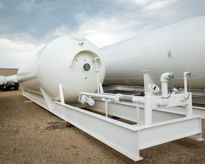 White horizontal storage tank mounted on a skid.