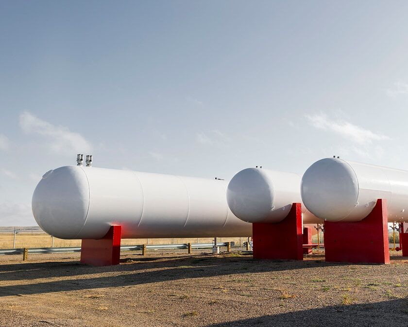 Large white horizontal propane storage tanks.