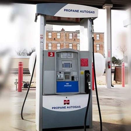 Propane autogas dispenser under a fueling canopy with hose and card reader, labeled “Propane Autogas.”