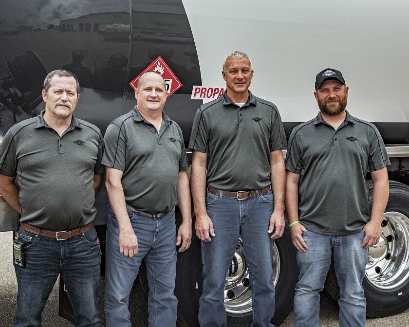 Westmor truck services team standing in front of a propane delivery truck. 