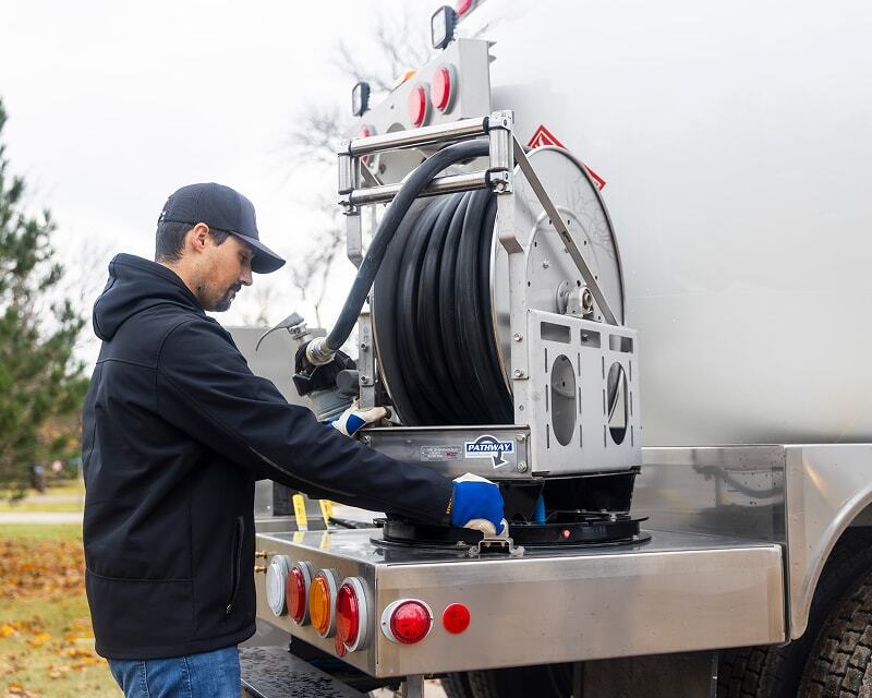  Propane delivery driver operating Westmor’s swiveling hose reel.