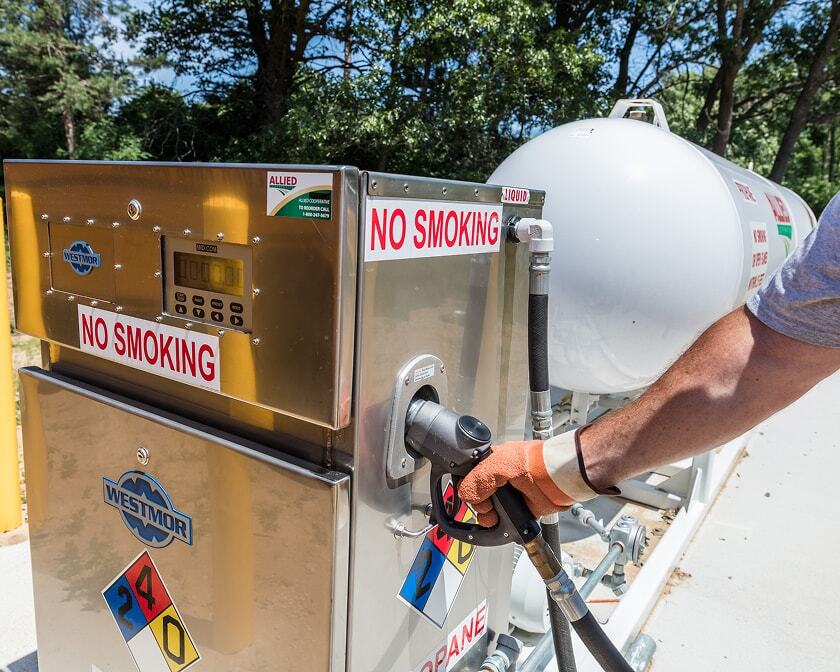 Propane autogas dispensing unit with aboveground storage tank inside a fenced area.
